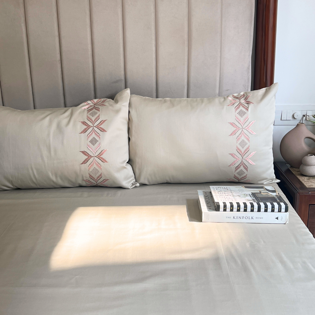 Nadine beige bedsheet folded showing embroidery detail