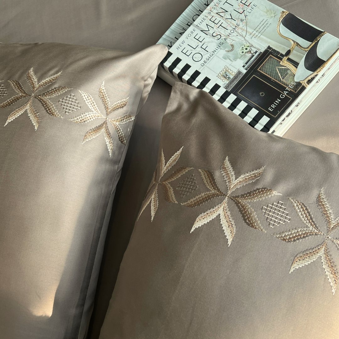 Nadine mocha bedsheet folded showing embroidery detail