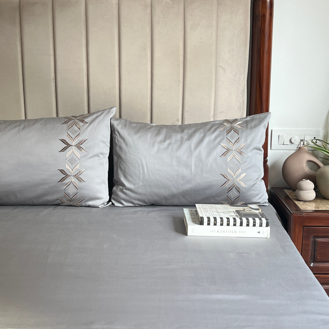 Nadine slate bedsheet folded showing embroidery detail