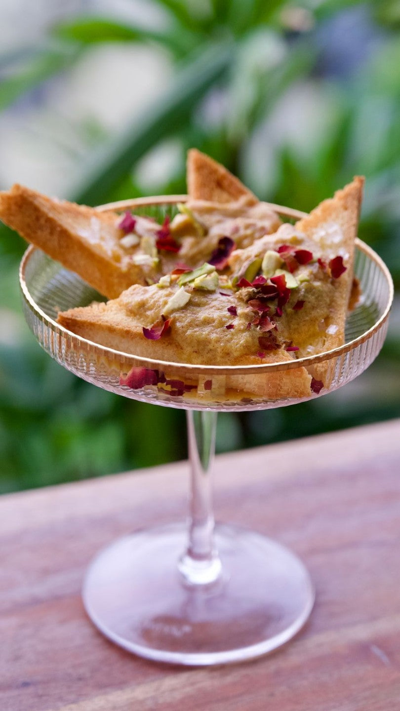 Dessert served in vintage Fitzgerald coupe glass with gold trim.