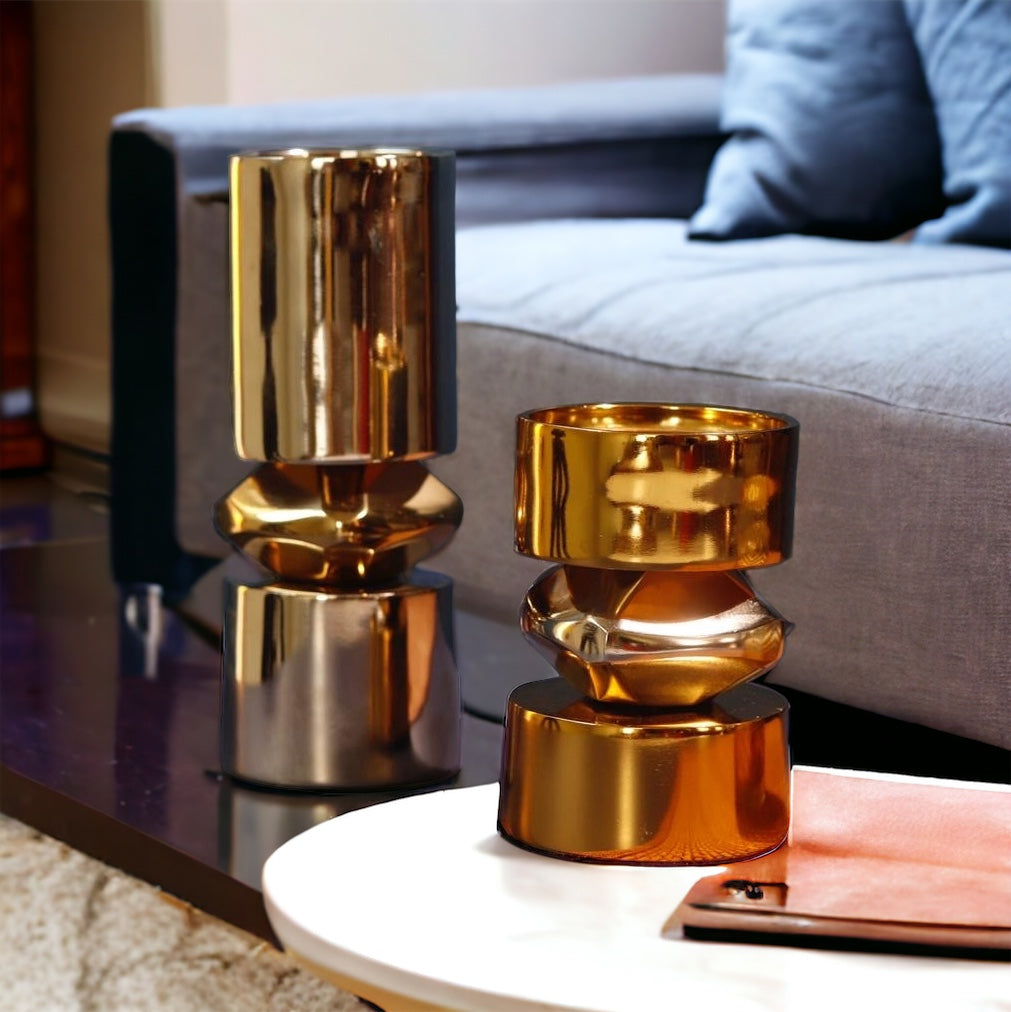 Modern gold and nickel metal candle stand with geometric shapes.