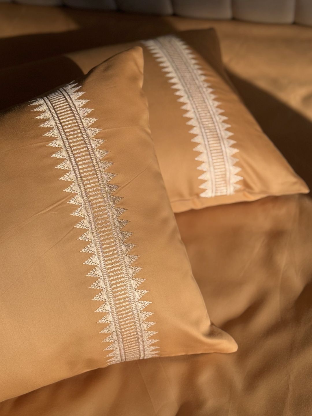 Close-up of honey mustard embroidered pillow cover