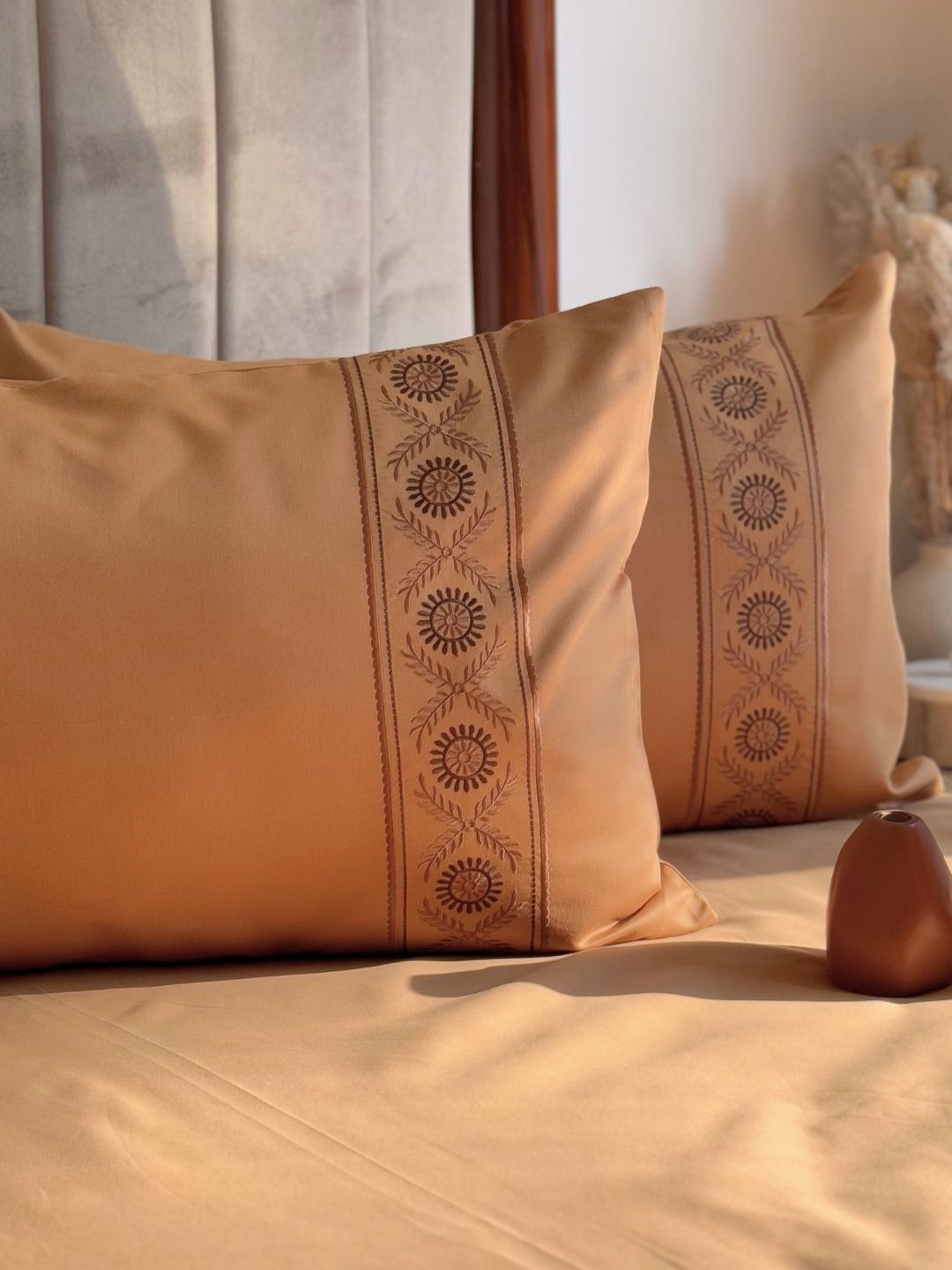 Close-up of embroidery on honey mustard pillow cover