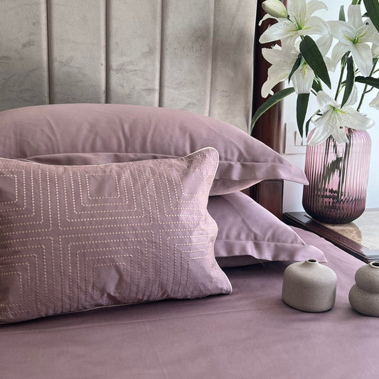 Cubicle old rose bedsheet set with accent cushion styled on bed