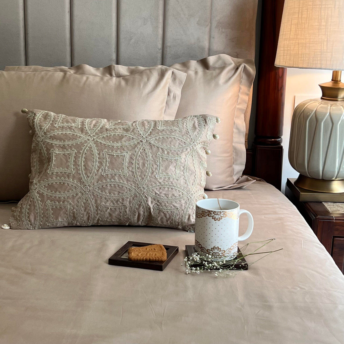 Stark sand bedsheet set with accent cushion styled on bed