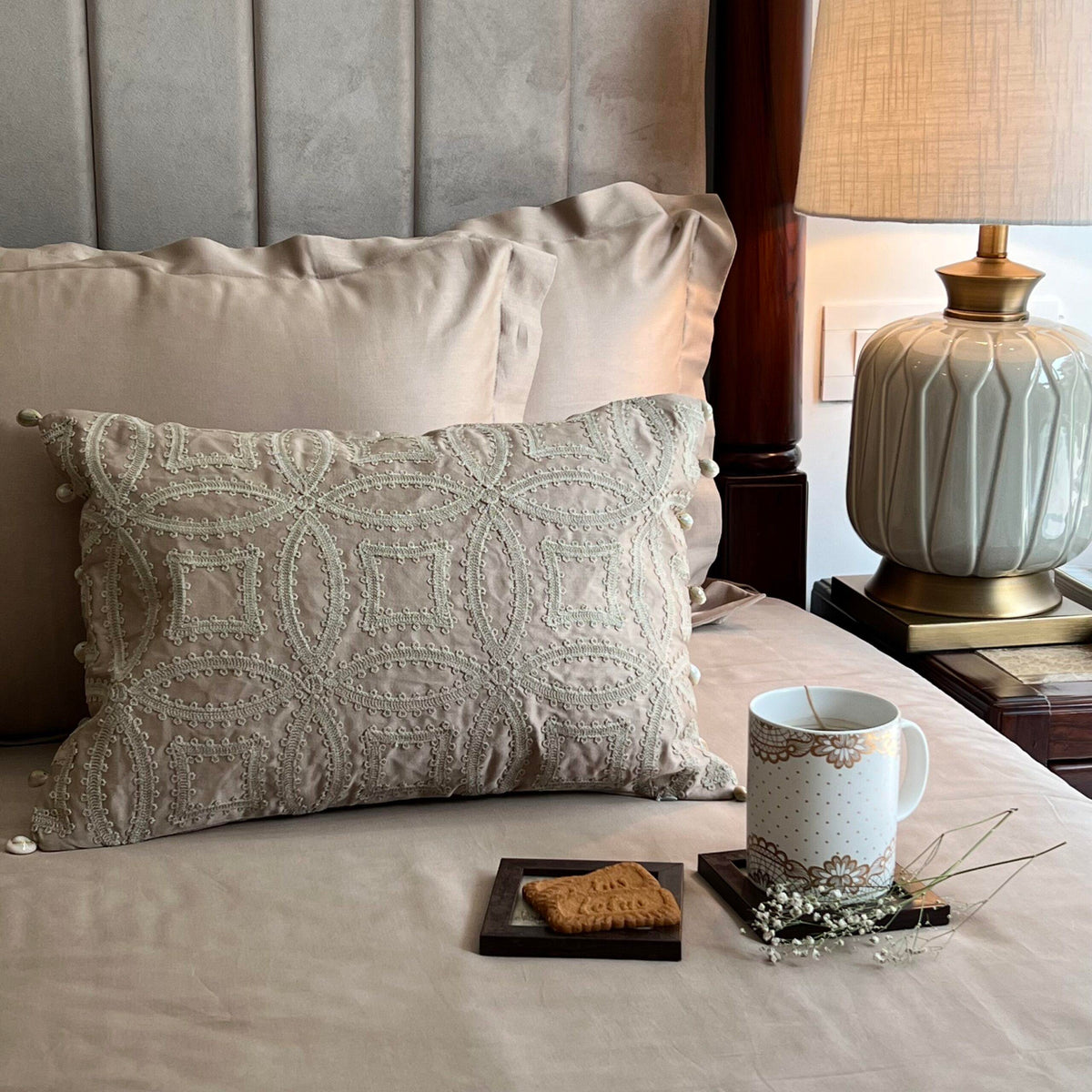 Close-up of Stark sand embroidered accent cushion cover