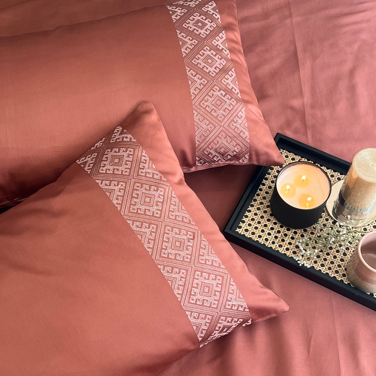 Terracotta bedsheet set styled on a bed
