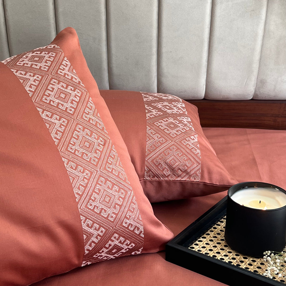 Close-up of embroidery on terracotta pillow cover