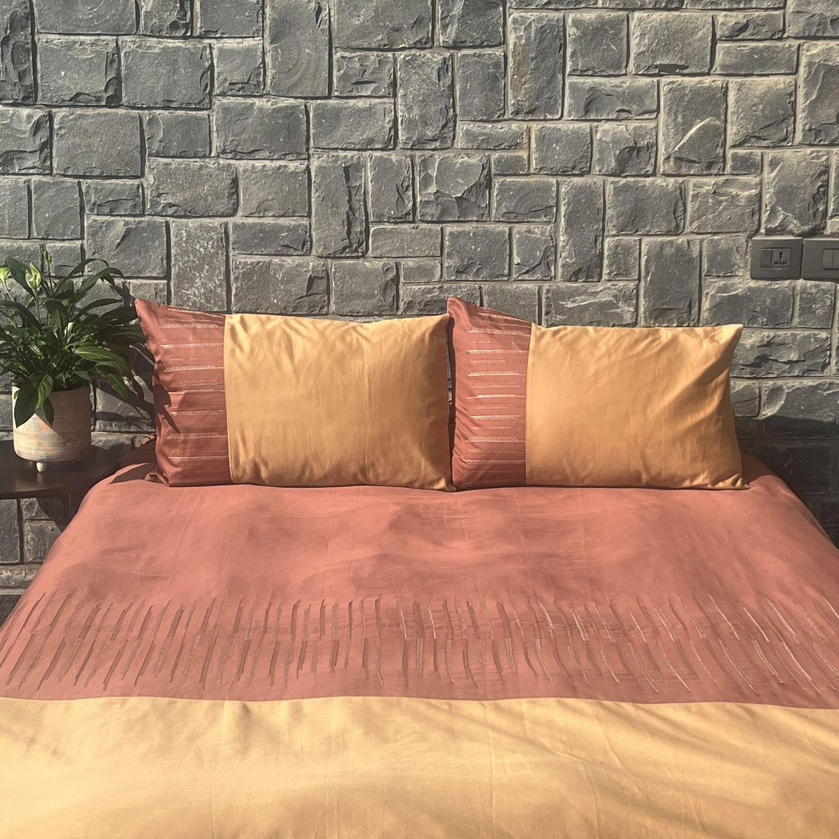 Speckle terracotta and honey mustard bedsheet set styled on bed