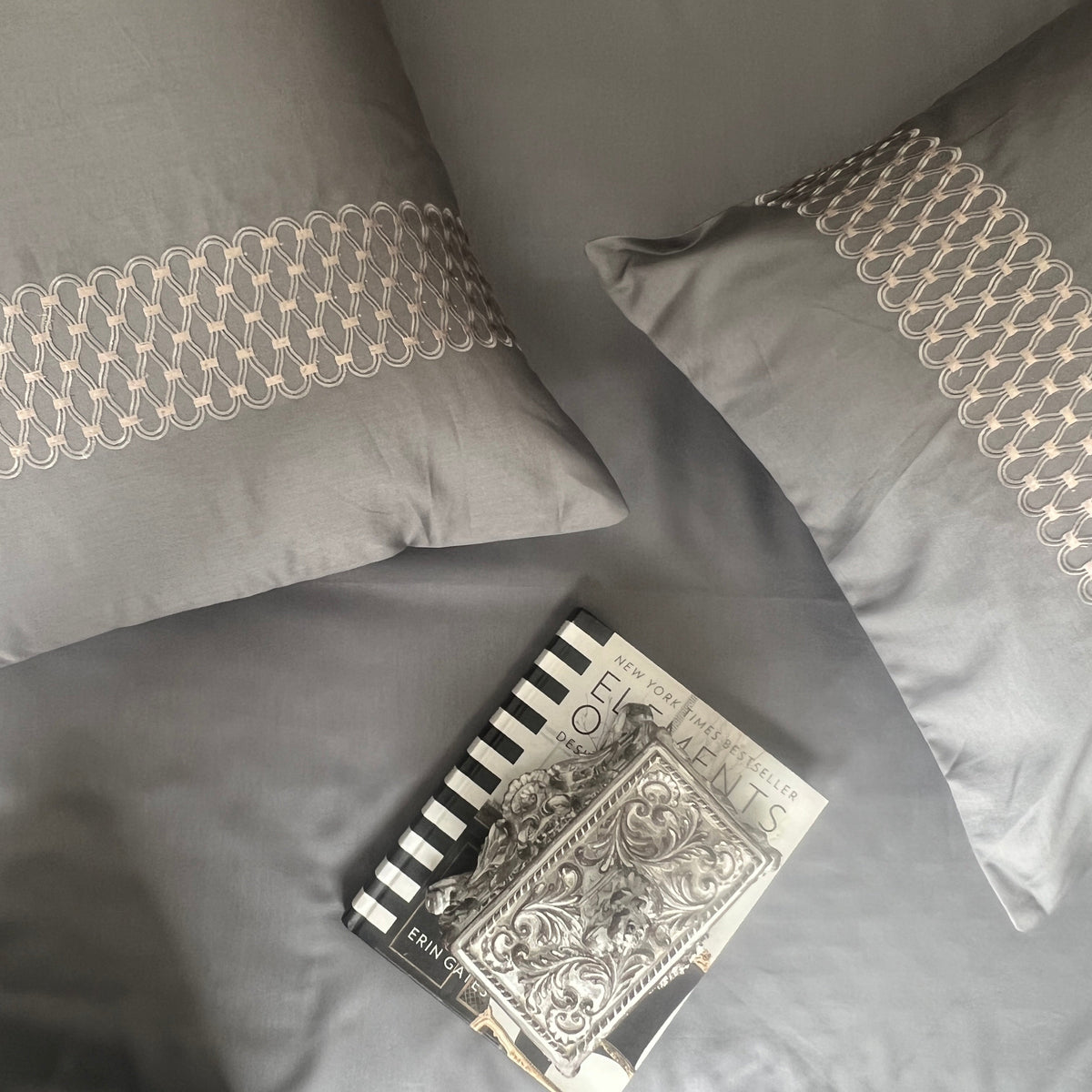 Close-up of dark grey embroidered pillow cover detail