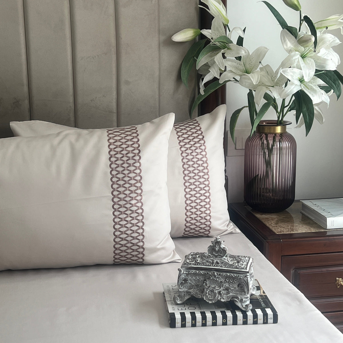 Ivory bedsheet set with embroidered pillow covers styled on bed