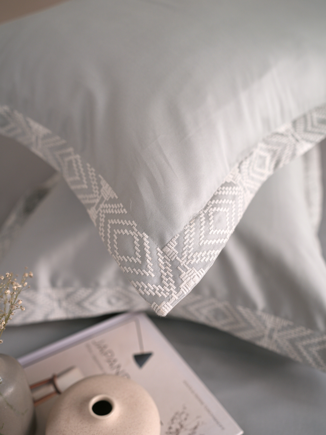 Close-up of the grey embroidered pillow cover