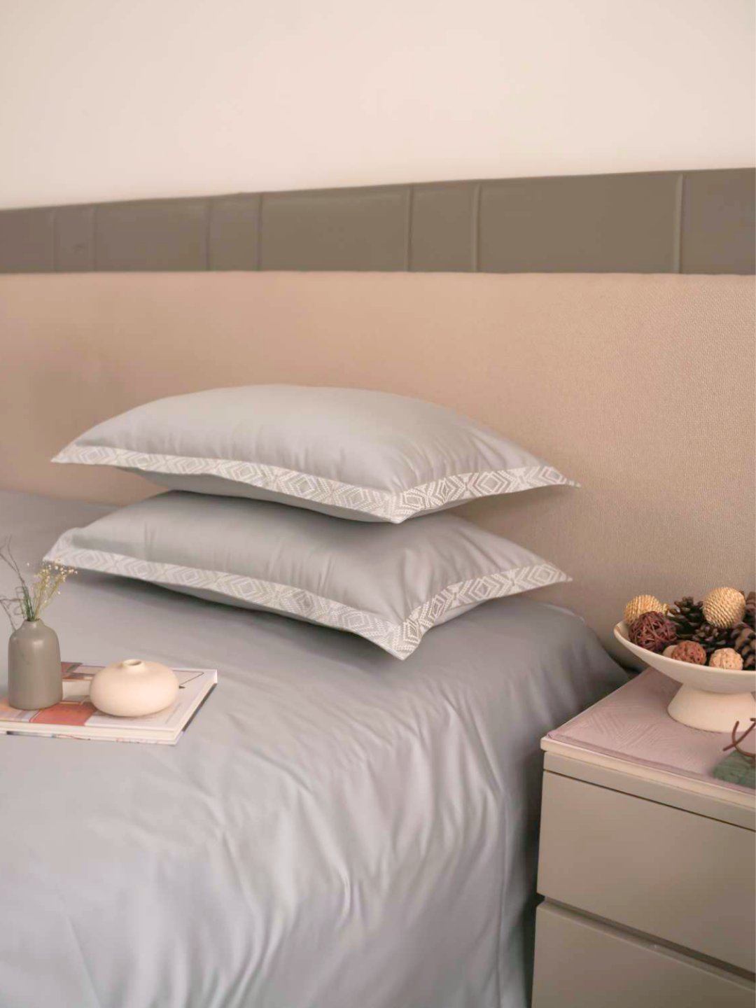 Folded stack of the grey bedsheet and pillow covers