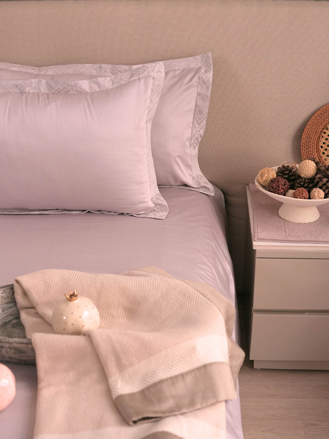 Lavender bedsheet set styled on a made bed