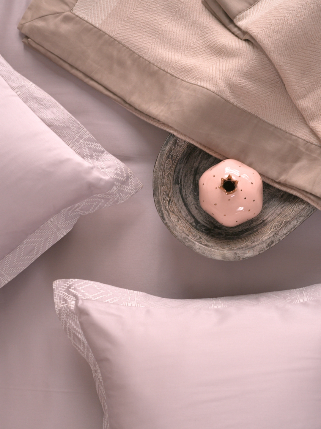 Folded stack of the lavender bedsheet and pillow covers