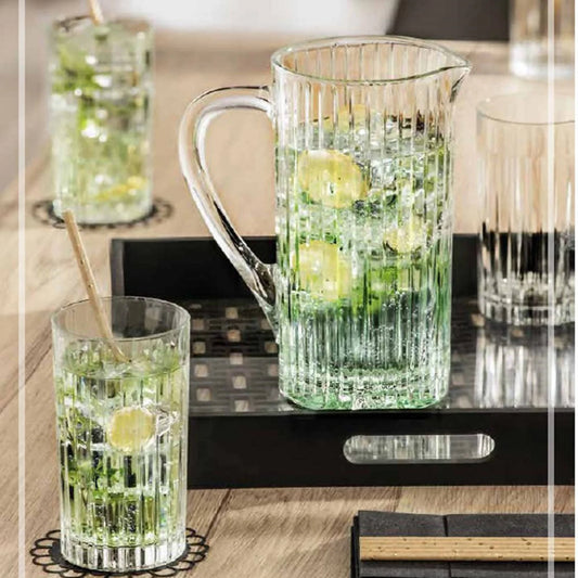 Ribbed design glass jug with refreshing drink, timeless kitchen serveware.