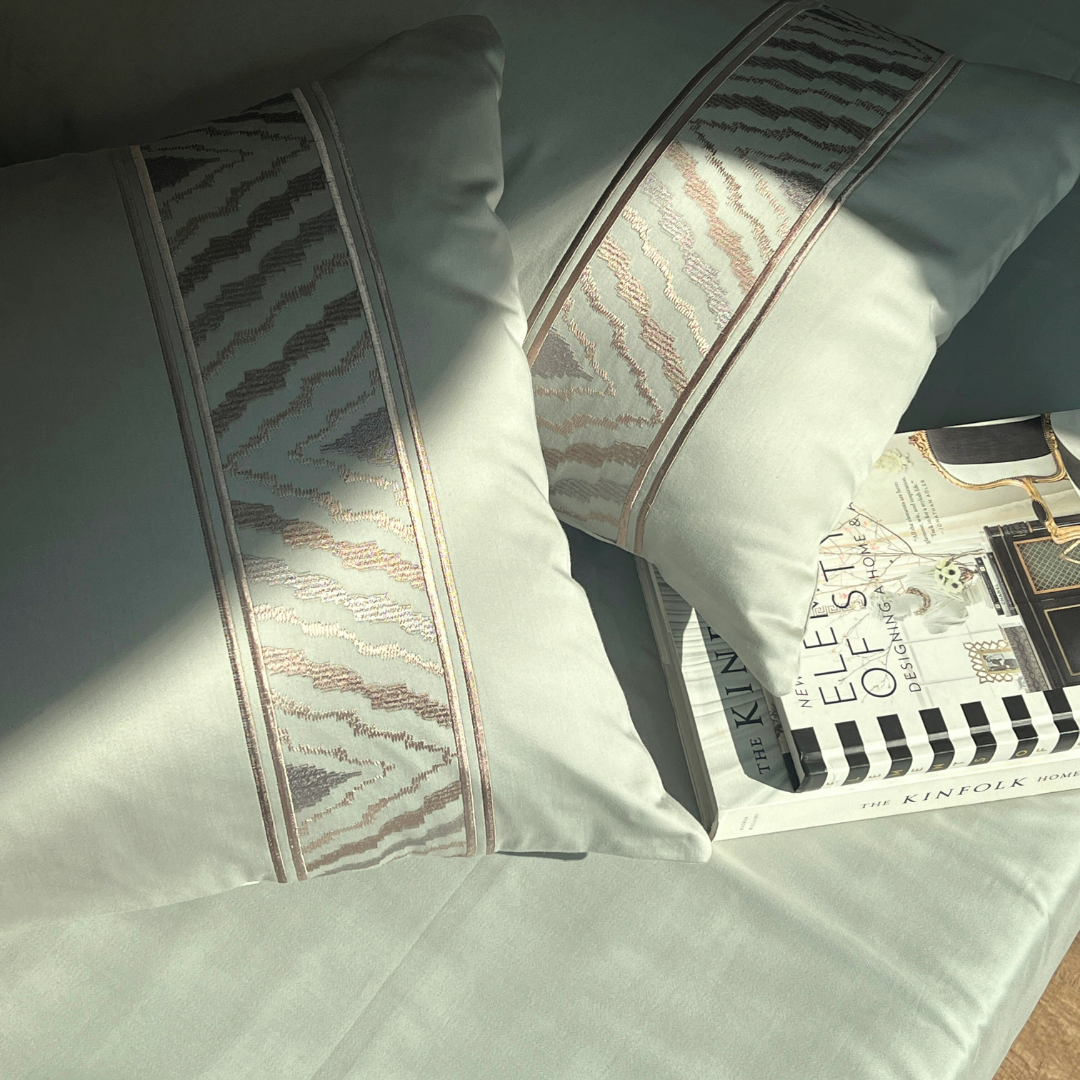 Close-up of sage green embroidered pillow cover