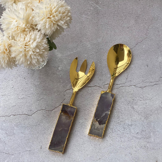 Golden salad server set with amethyst stone handles.