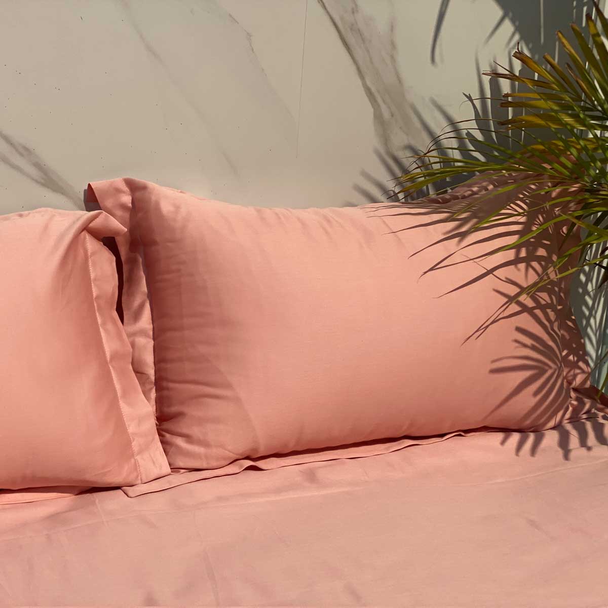 Close-up of the coral cotton satin bedsheet fabric texture