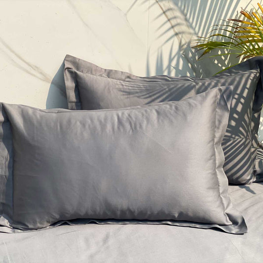 Dark grey bedsheet styled on a made bed