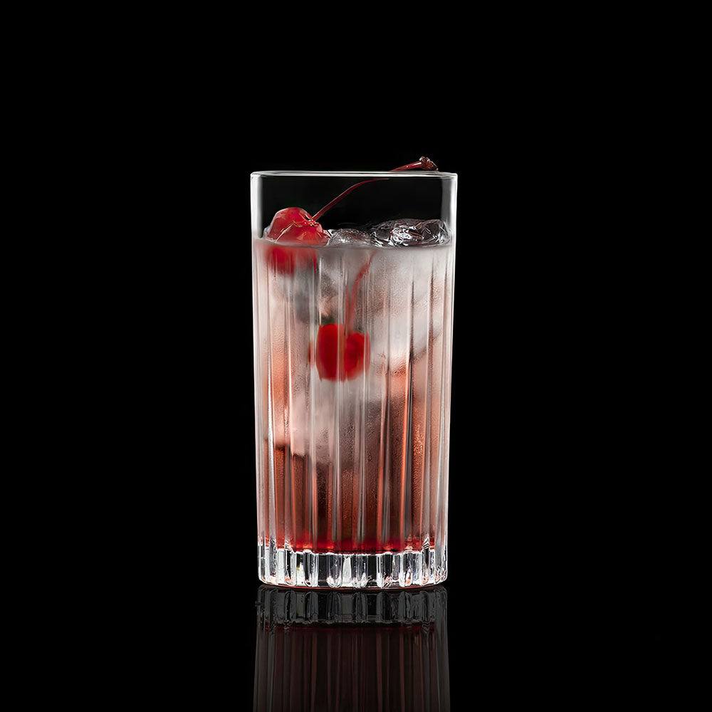 Highball glass filled with a drink, ice, and cherries; timeless glass design.