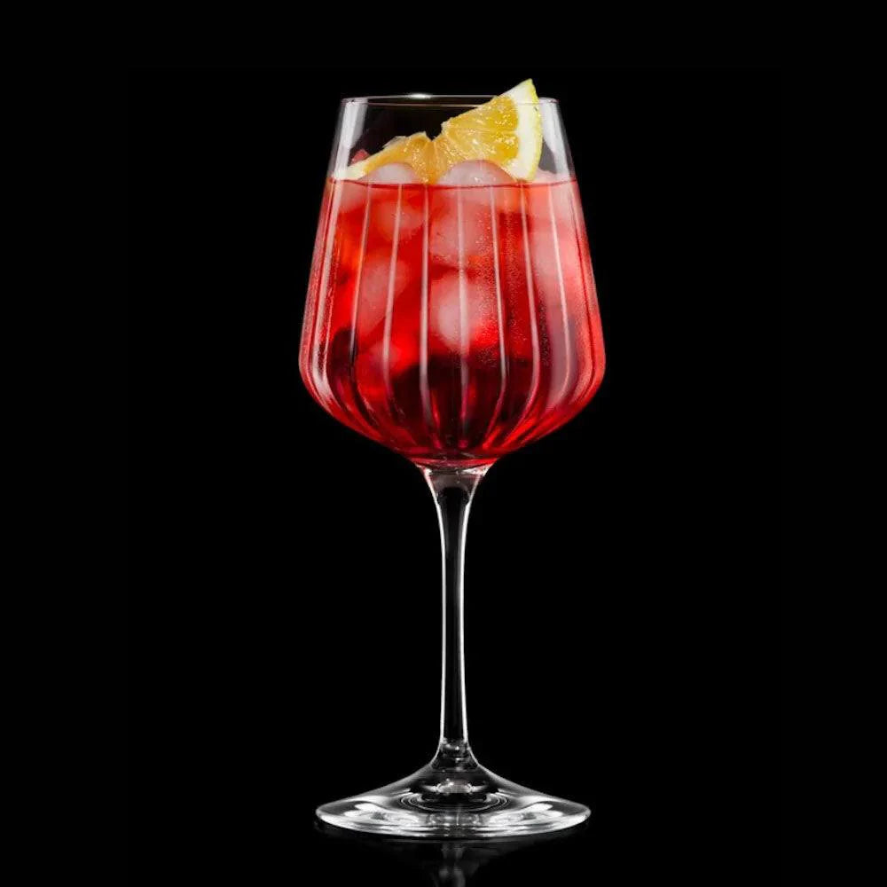 Elegant Spritz glass with ribbed design, filled with refreshing drink and orange slice.