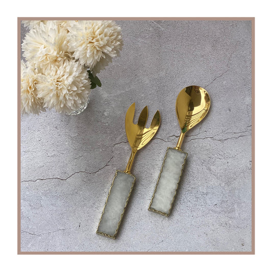 Gold salad servers with quartz handles for stylish dining.